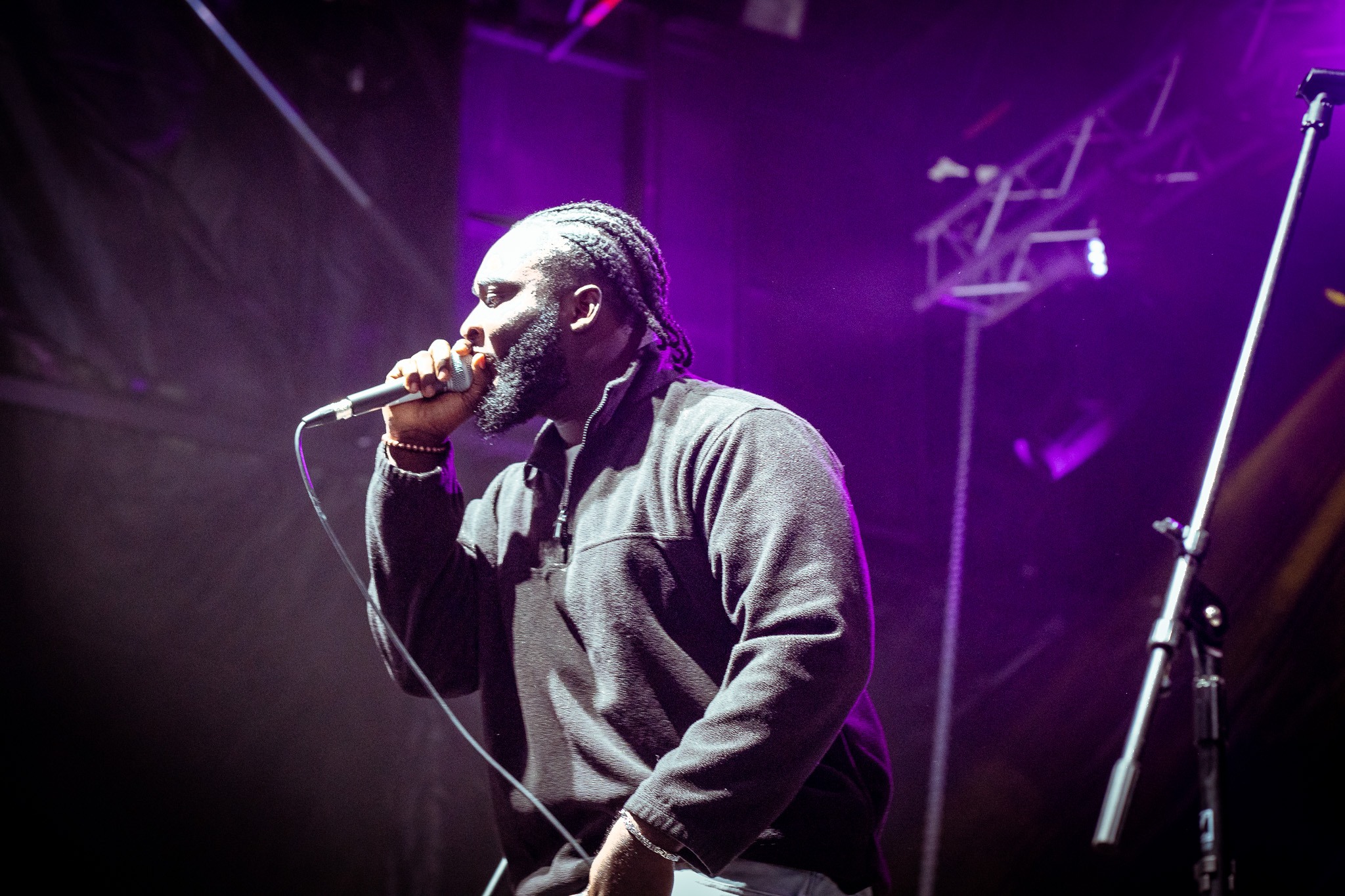 Live performer in purple stage lighting